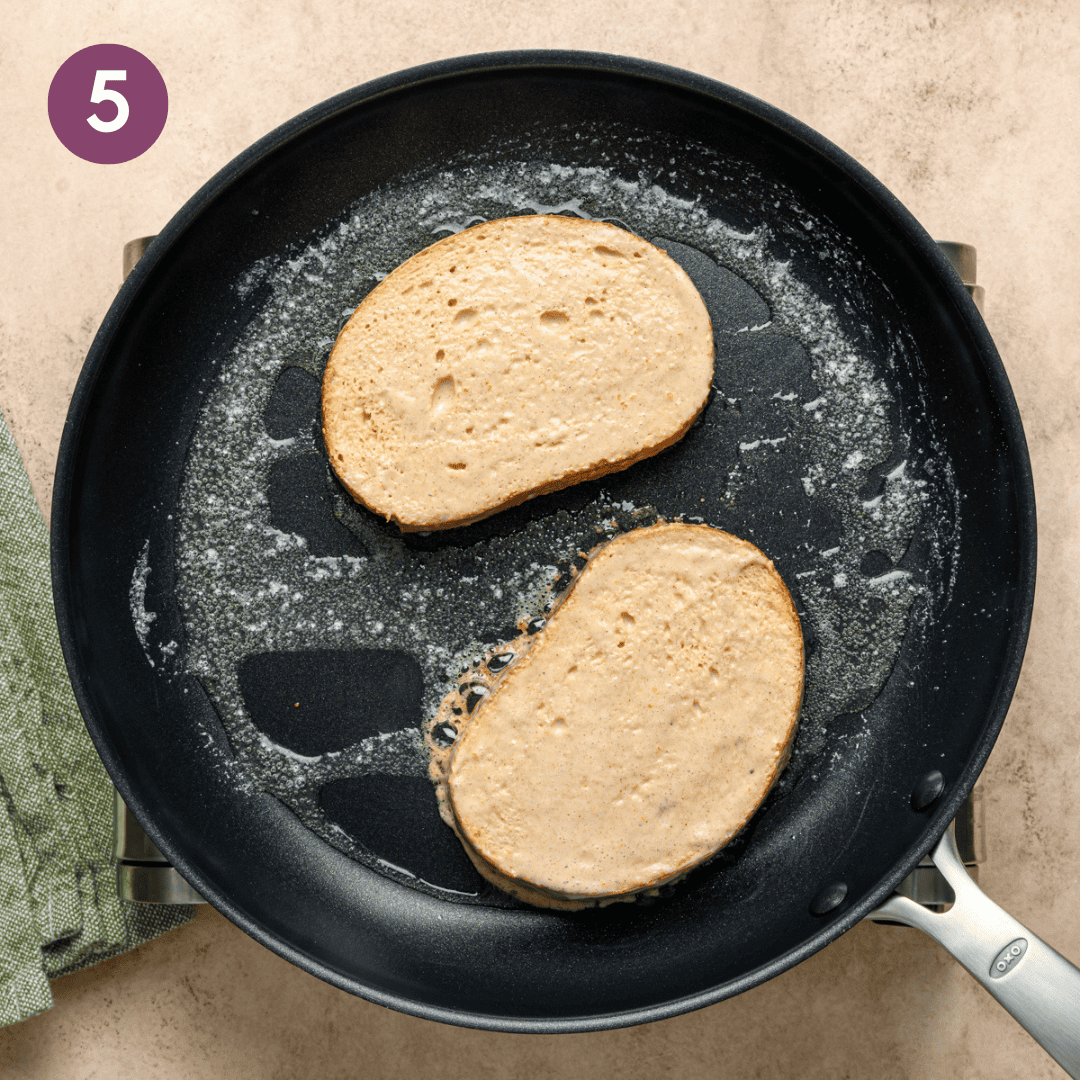 french toast cooking in butter and oil in a skillet.