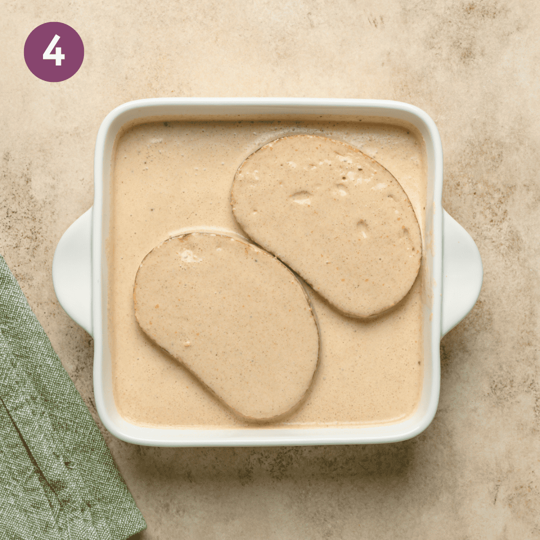 french toast batter and bread in a baking dish.