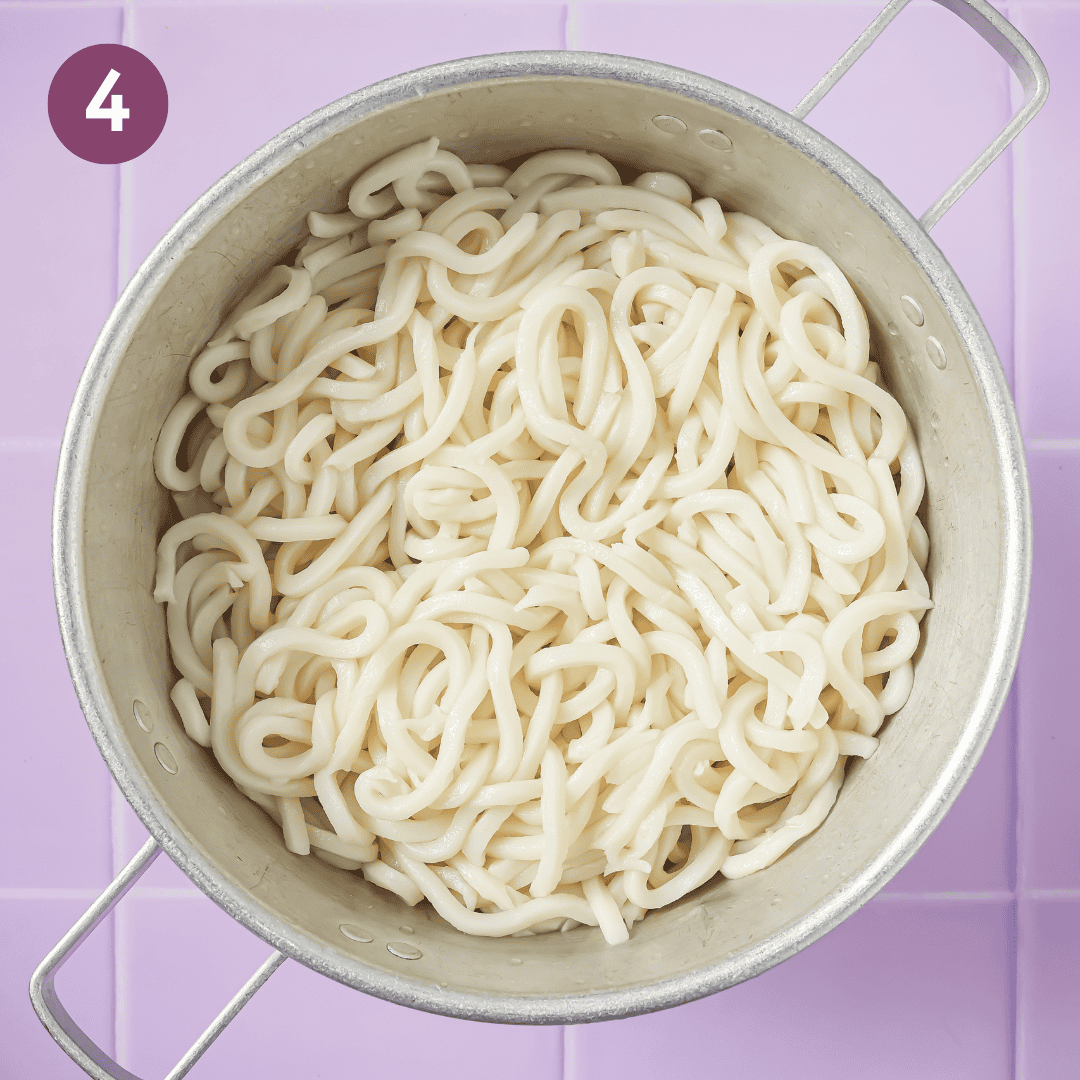 cooked and drained udon noodles in a bowl.