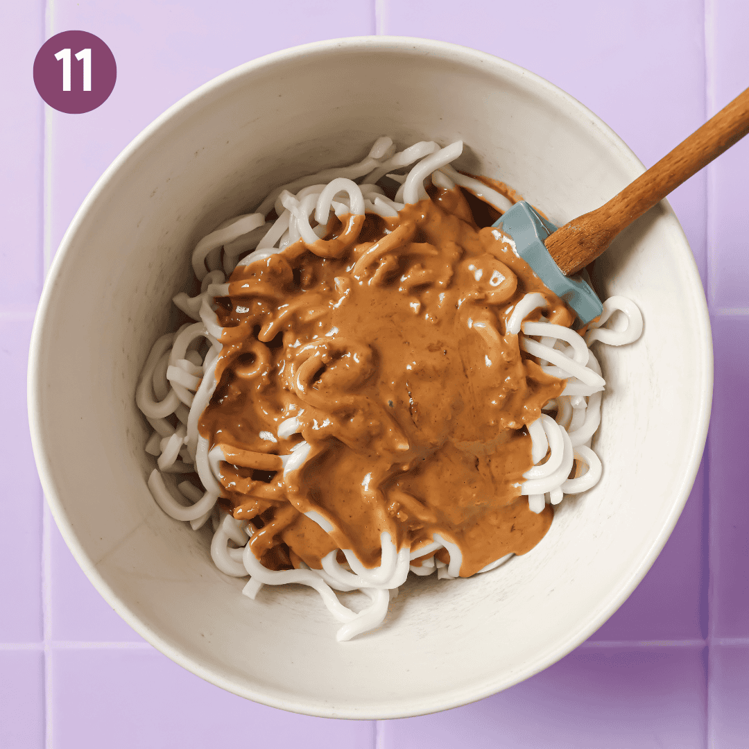 peanut sauce poured over the bowl of noodles.