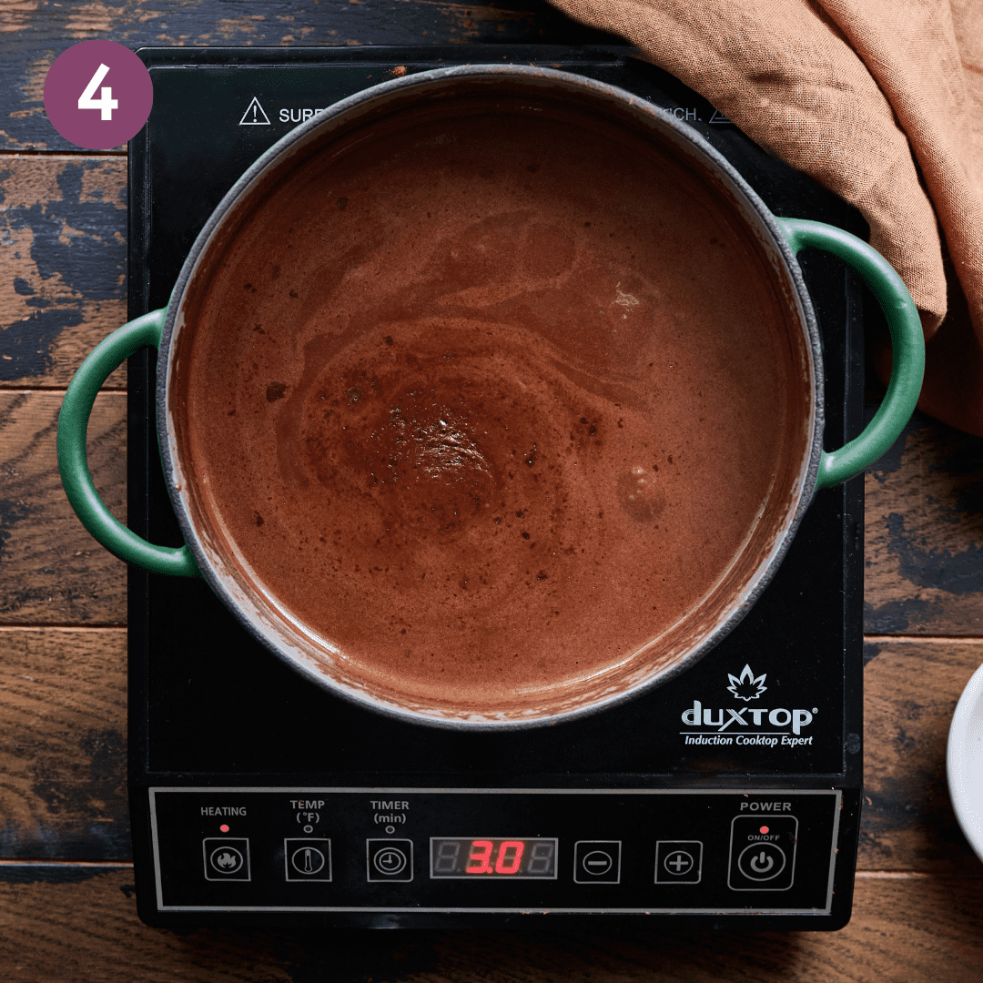 Creamy hot chocolate mixture in pot.